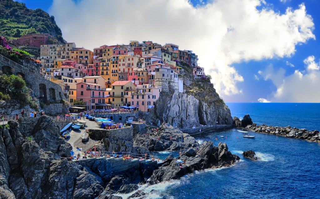 colourful houses located on an Italian cliff edge next to the sea