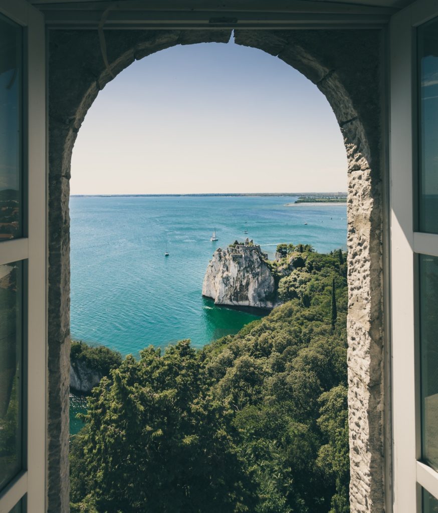window view overlooking a calm italian island sea