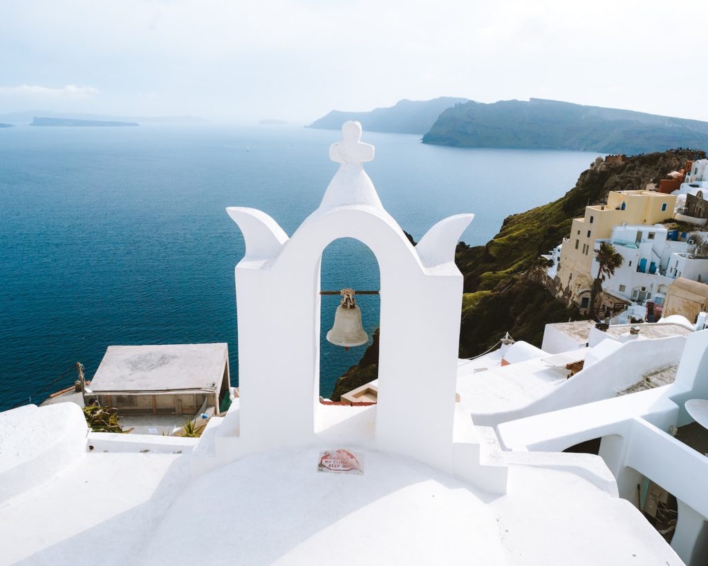 view point on top of a white concrete church on a Greek island