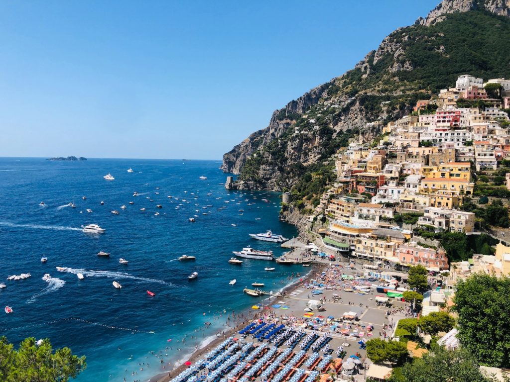 an italian coastal town overlooking the sea filled with boats