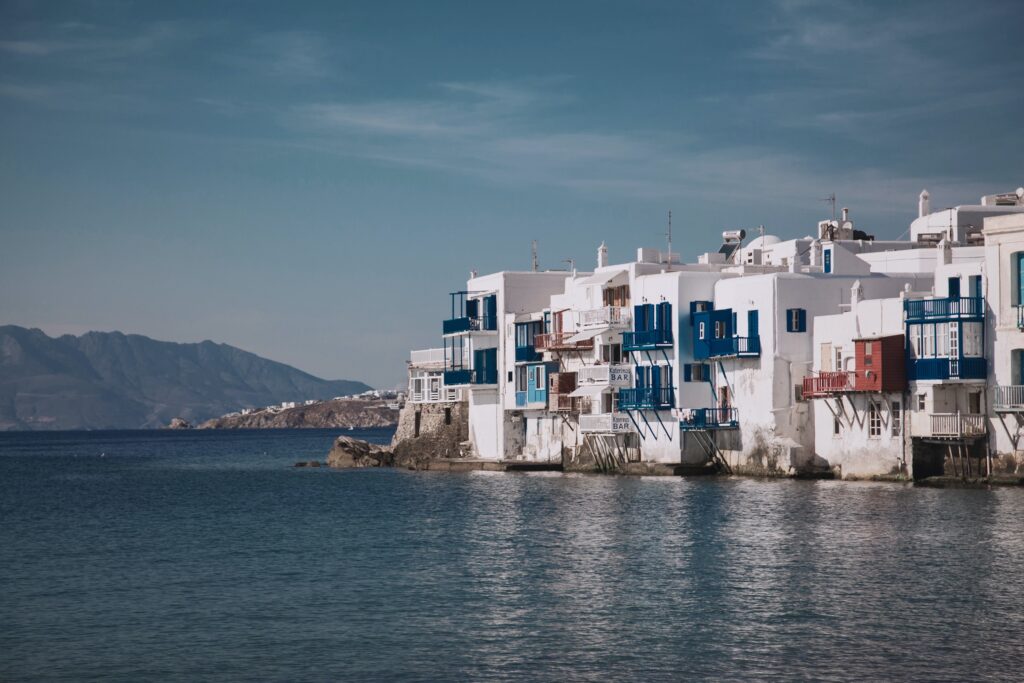 Whitewashed buildings on the coast which can be visited during Mykonos holidays.