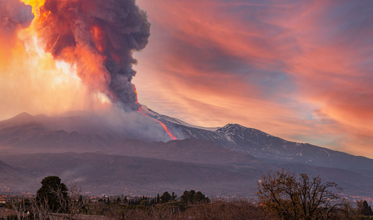 mount etna eruption with ash clouds and a red sky
