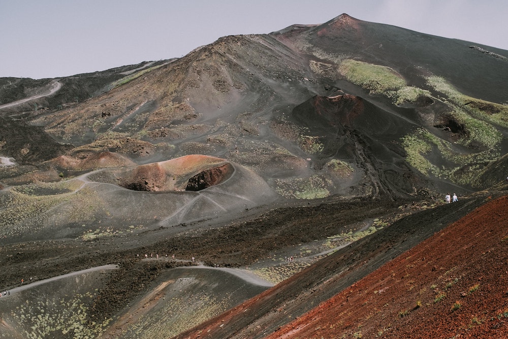 the top of mount etna where people are hiking